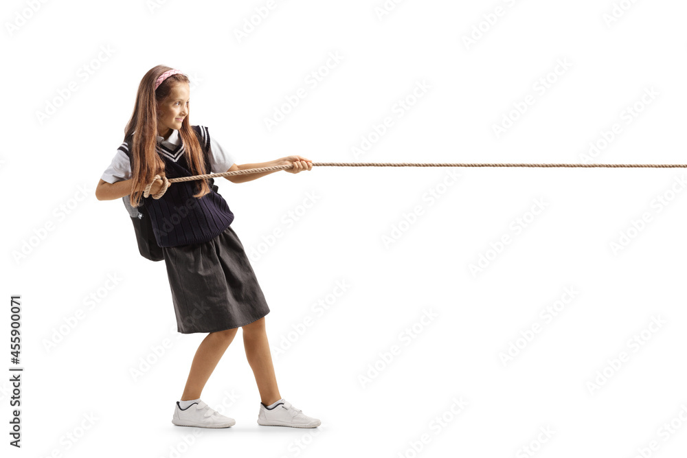 Full length profile shot of a schoolgirl pulling a rope Full length profile shot of a schoolgirl pulling a rope