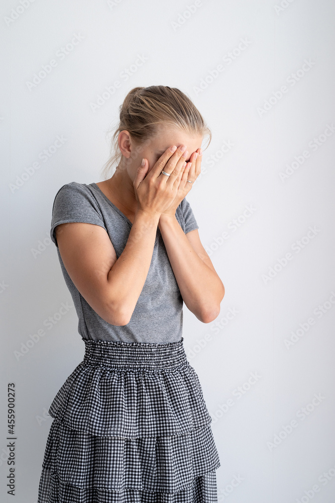 portrait of woman covering her face with hands portrait of woman covering her face with hands
