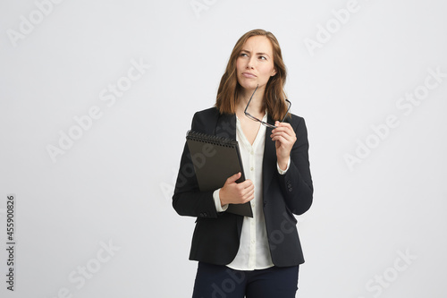 Fotografija Portrait of a beautiful brunette business woman looking like she's considering s