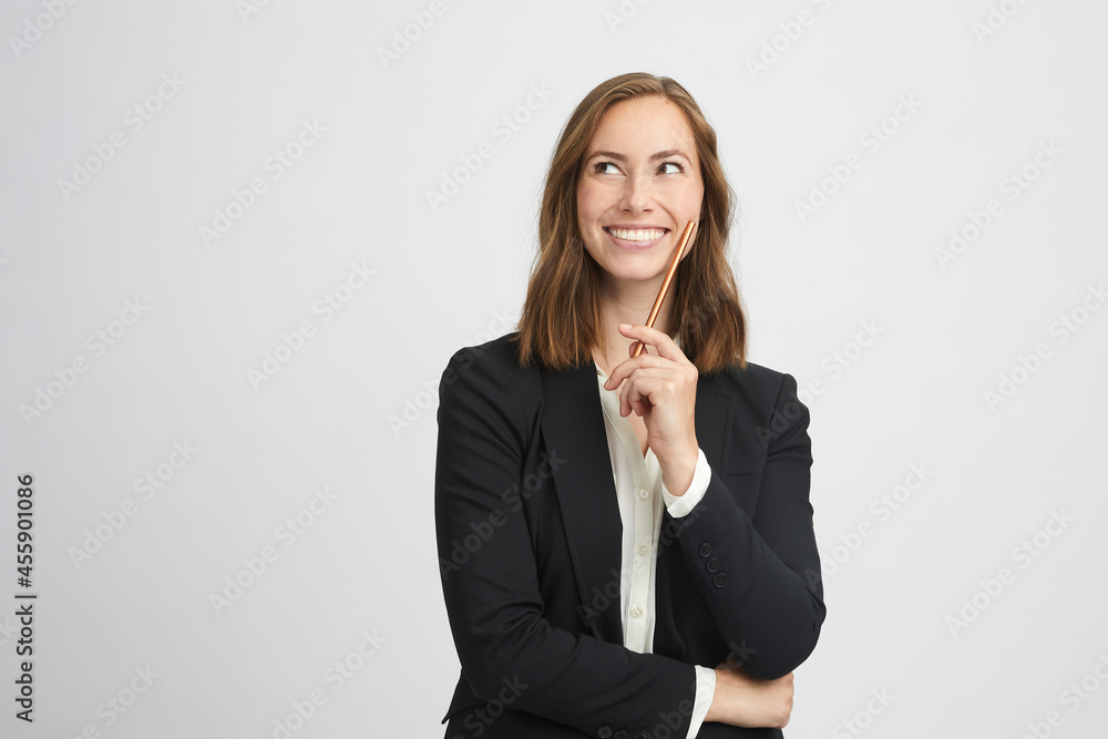 Beautiful portrait of a pretty business woman looking up to the left while she smiles and gets a good idea Beautiful portrait of a pretty business woman looking up to the left while she smiles and gets a good idea