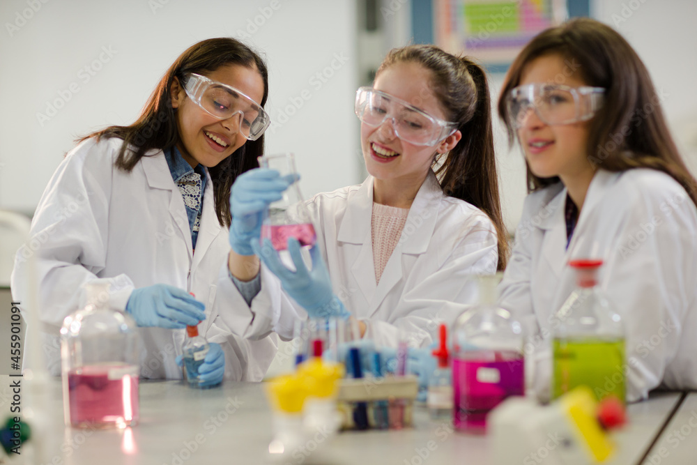 Girl students conducting scientific experiment in laboratory classroom Girl students conducting scientific experiment in laboratory classroom