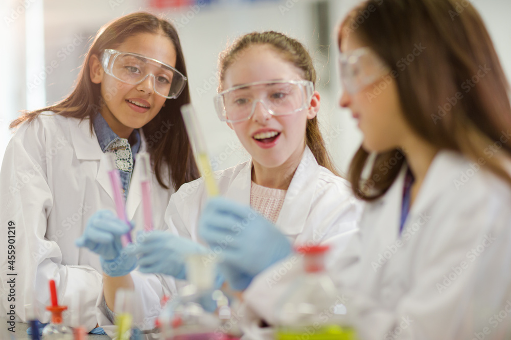 Girl students conducting scientific experiment in laboratory classroom Girl students conducting scientific experiment in laboratory classroom