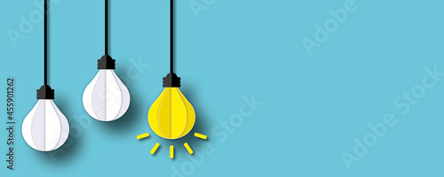 Glowing of light bulb on a blue background, Unique or different creative idea concepts, Innovation thinking creative, Success inspiration, leadership, Business idea, paper art design style. photo