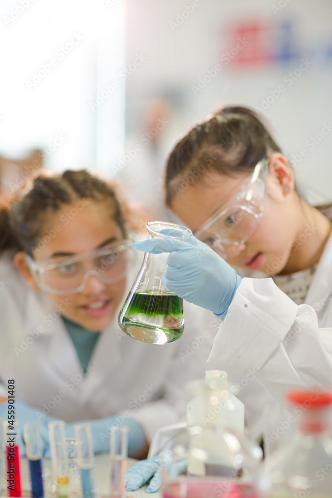 Students watching chemical reaction, conducting scientific experiment in laboratory classroom Students watching chemical reaction, conducting scientific experiment in laboratory classroom