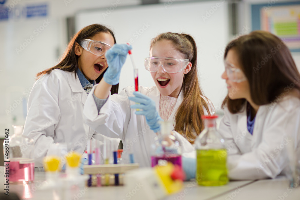 Girl students conducting scientific experiment in laboratory classroom Girl students conducting scientific experiment in laboratory classroom