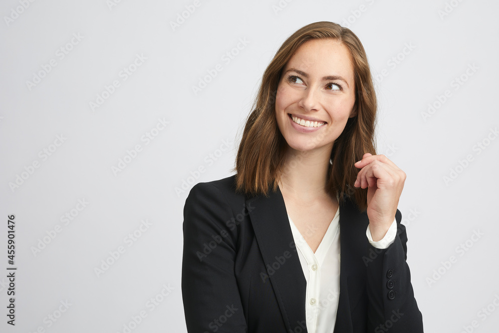 Portrait of a young beautiful business woman looking to the left, smiling and thinking on white background Portrait of a young beautiful business woman looking to the left, smiling and thinking on white background