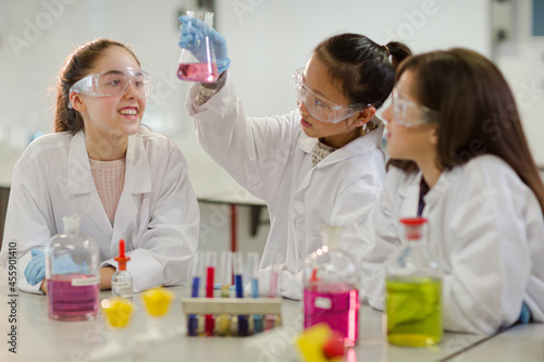 Girl students conducting scientific experiment in laboratory classroom