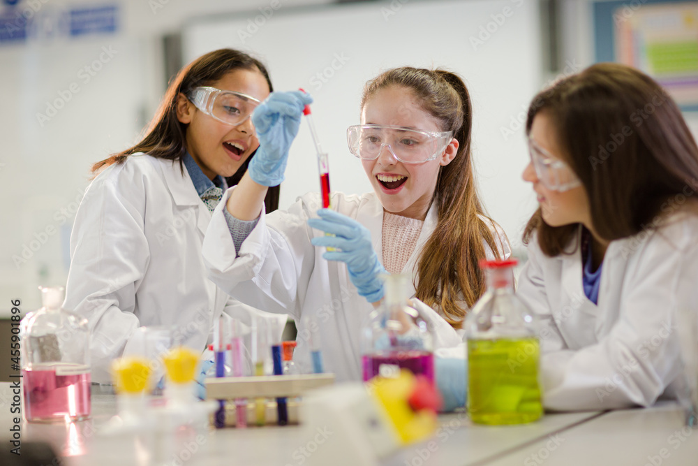 Girl students conducting scientific experiment in laboratory classroom Girl students conducting scientific experiment in laboratory classroom