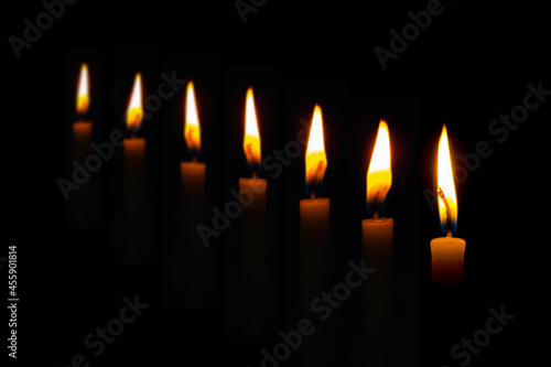 candle with fire in dark black background. buddhim Worship religious ritual concept.