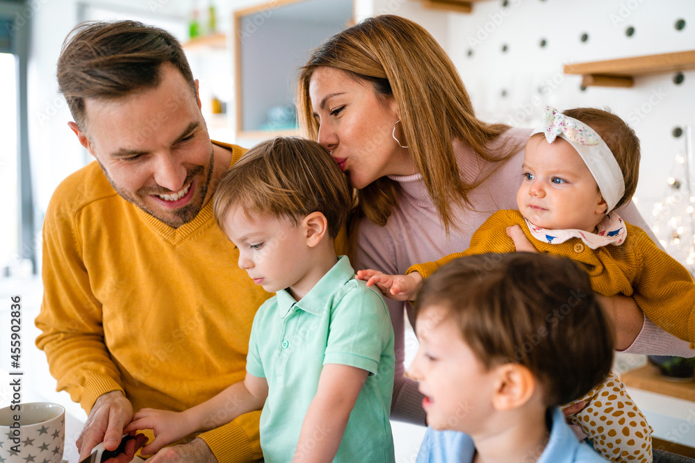 Happy family preparing healthy food together in kitchen Happy family preparing healthy food together in kitchen