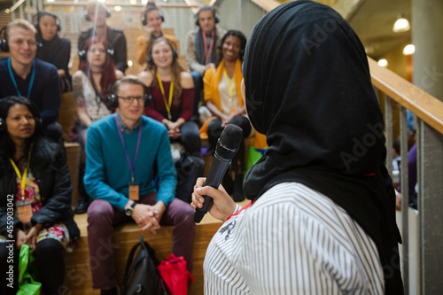 Female speaker in hijab talking to audience