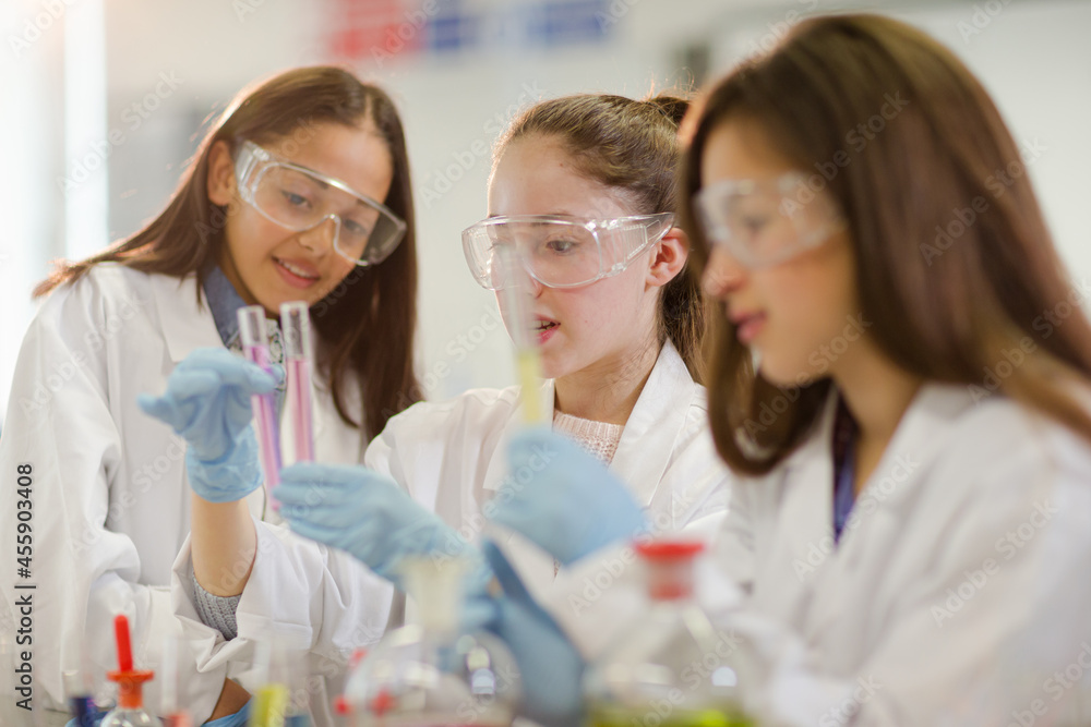 Girl students conducting scientific experiment in laboratory classroom Girl students conducting scientific experiment in laboratory classroom