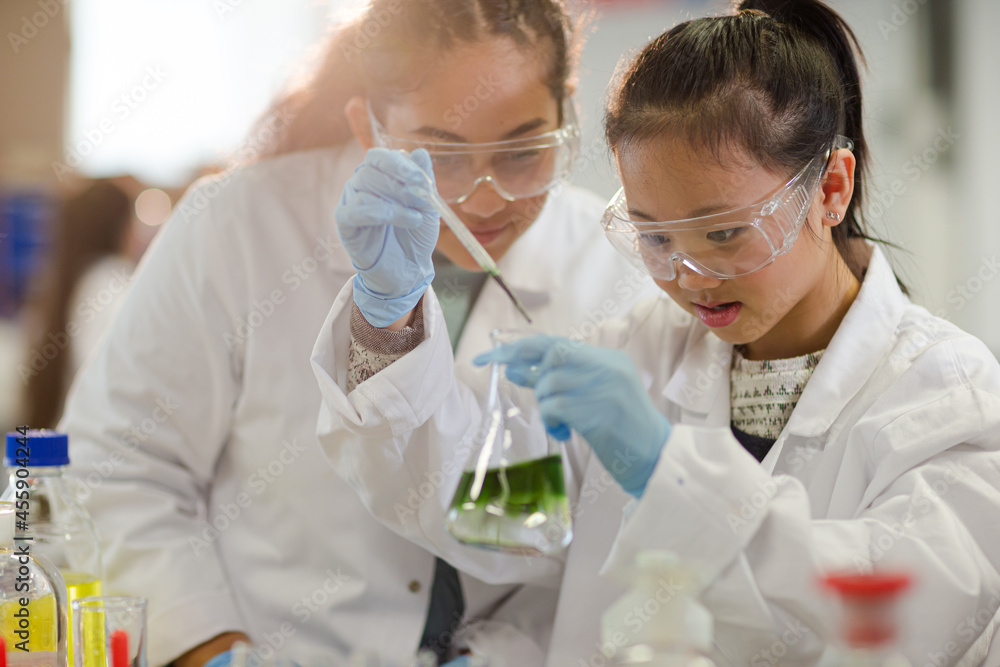 Students watching chemical reaction, conducting scientific experiment in laboratory classroom Students watching chemical reaction, conducting scientific experiment in laboratory classroom