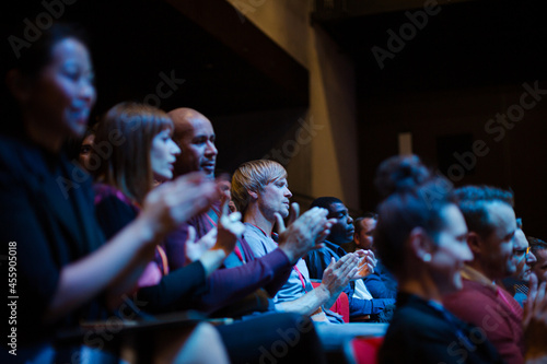 Enthusiastic audience clapping and cheering