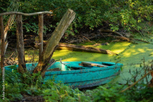 Photo of an old boat in the lake.