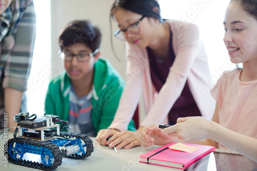 Students playing with robot in classroom