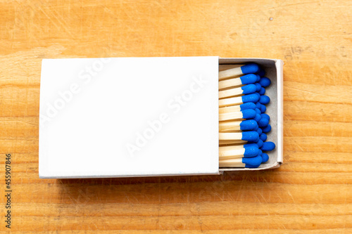 Cardboard box with matchsticks on wooden background, blank space top view. Space for design,flat lay copy space.Selective focus.
