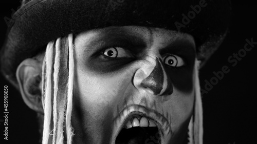 Obraz na plátne Close up footage of sinister man face with horrible Halloween skeleton makeup