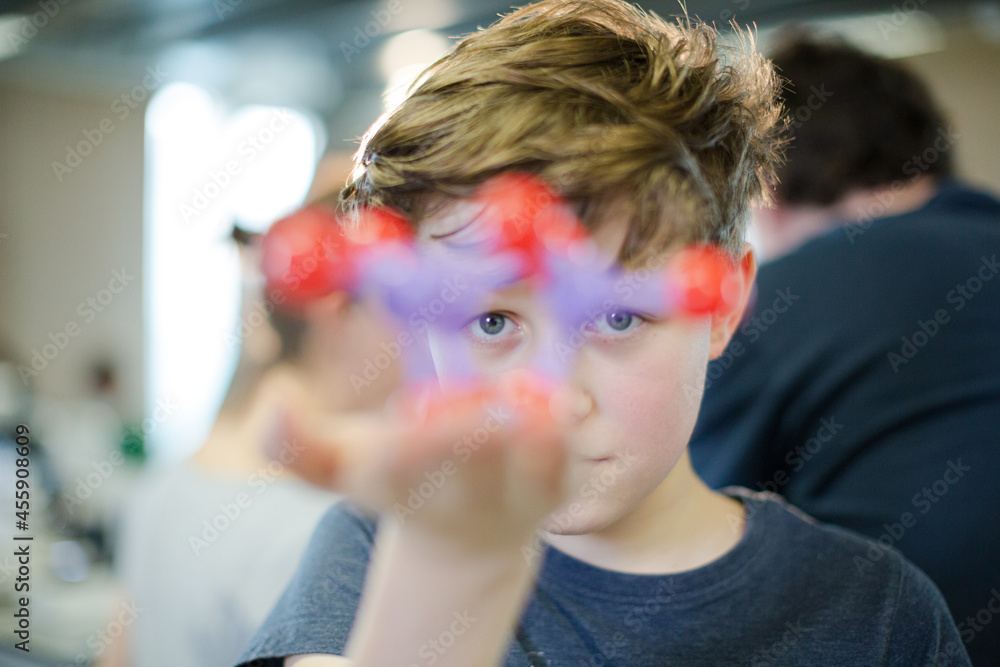 Obraz premium Curious boy examining molecule model in laboratory classroom