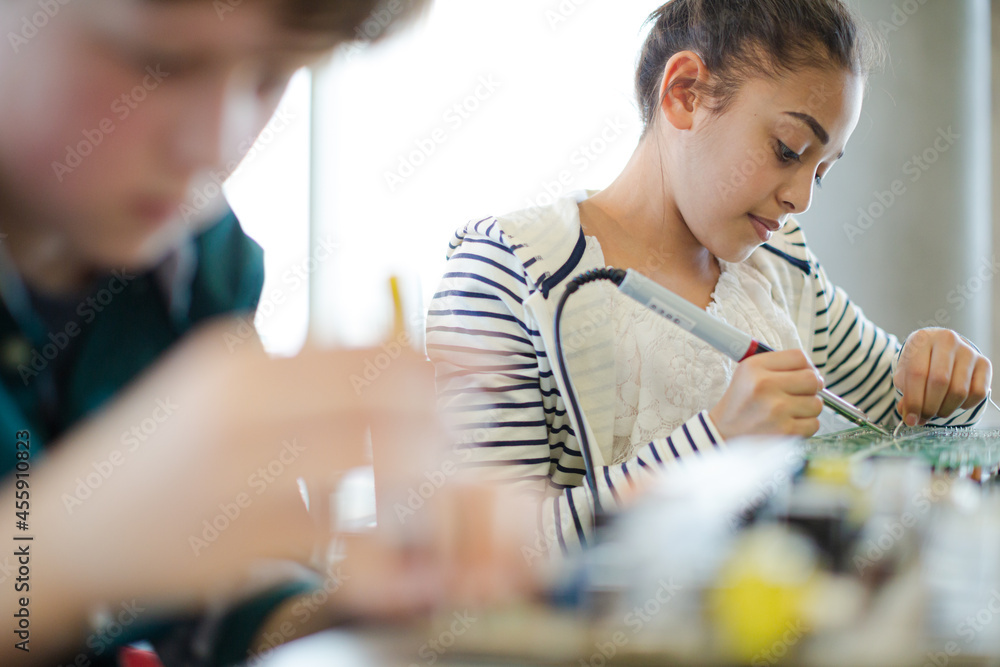 Fototapeta premium Students assembling computer in classroom