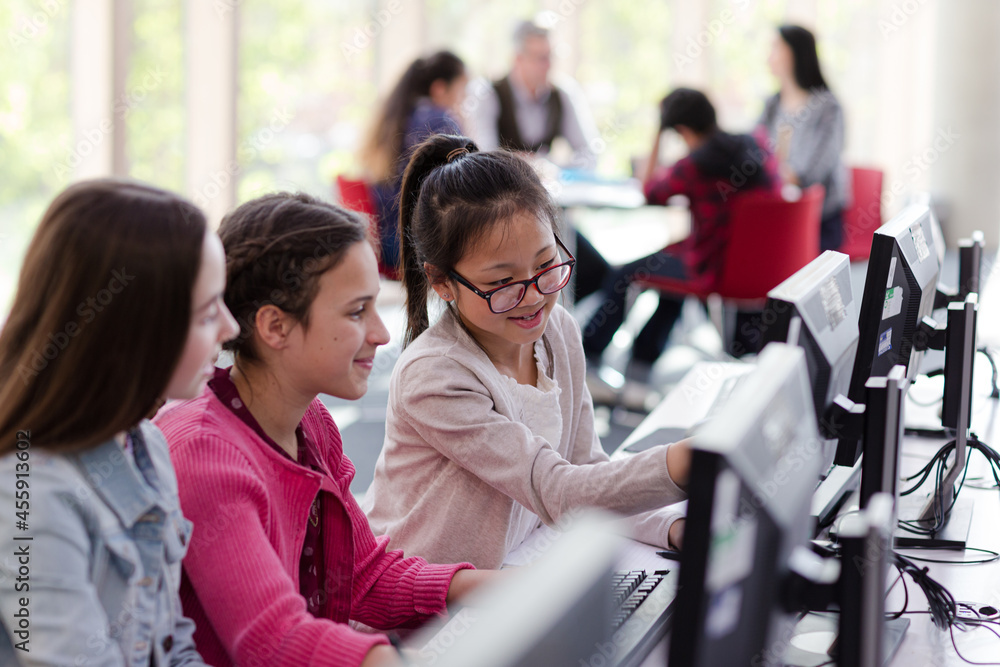 Fototapeta premium Girl students using computer in library