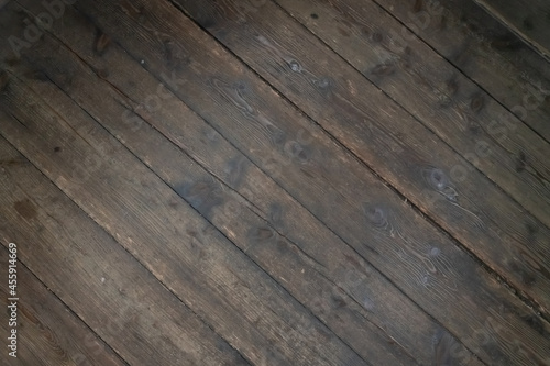 wooden background from dark brown planks folded inclined planks