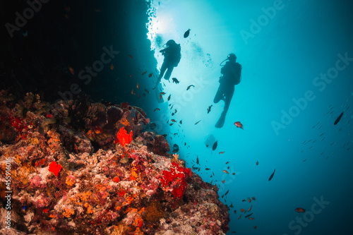 Fototapeta Naklejka Na Ścianę i Meble -  Underwater image of scuba diver among colorful coral reef in beautiful clear blue ocean