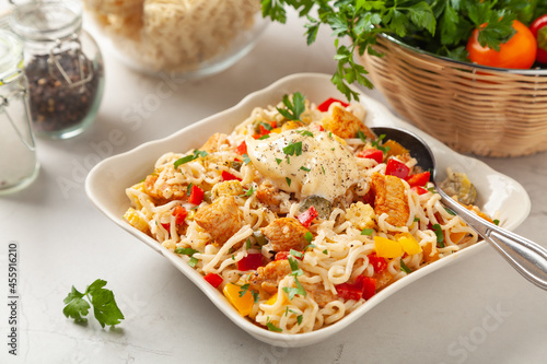 Salad with Chinese noodles and chicken, pepper, and cucumber.