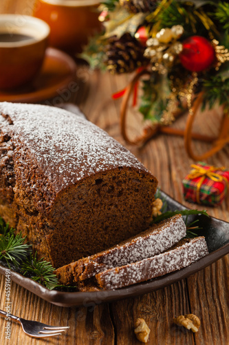 Homemade gingerbread cake. Christmas decoration. Front view. Natural wooden background.