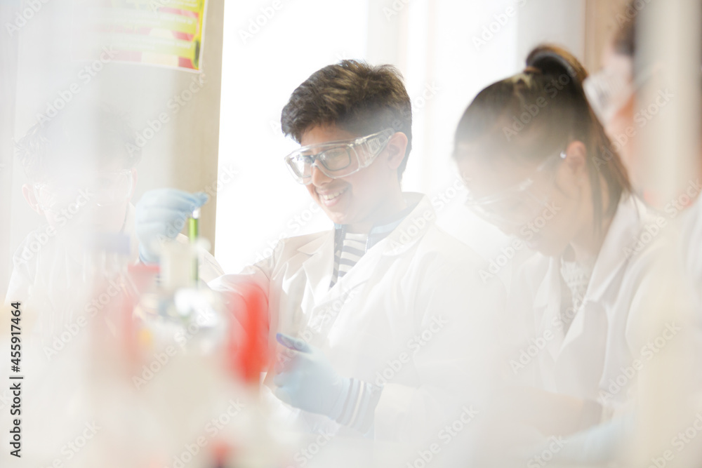 Students conducting scientific experiment in laboratory classroom Students conducting scientific experiment in laboratory classroom