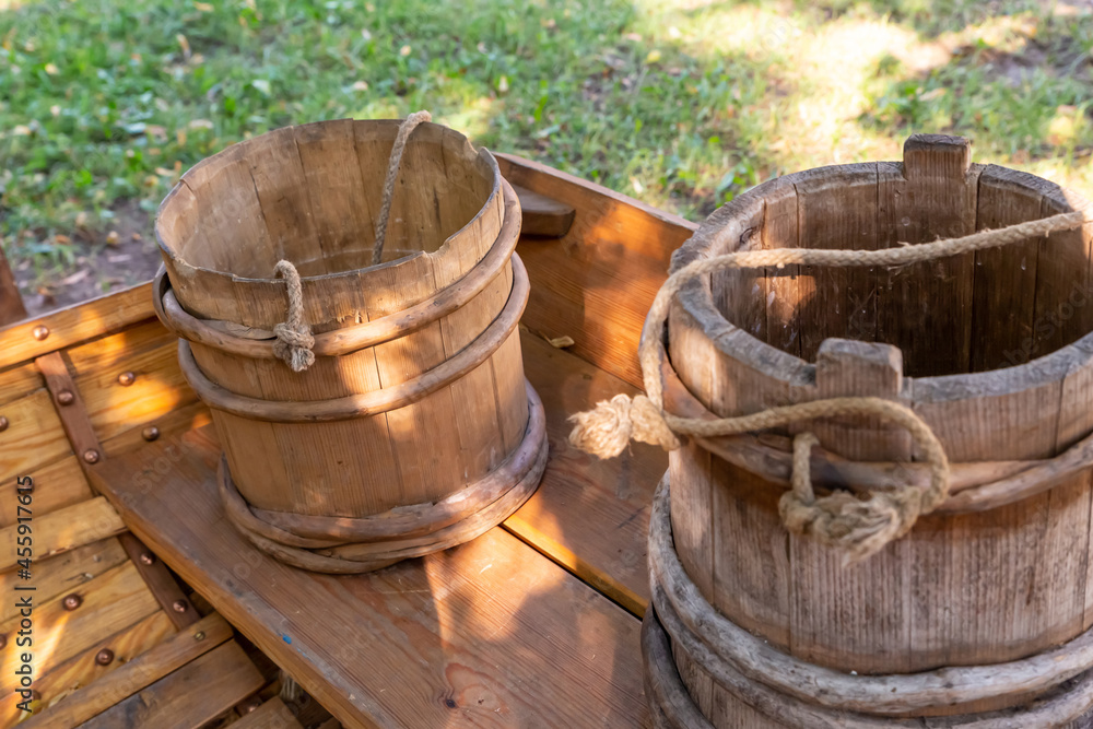 pair of traditional wooden buckets stand on a bench pair of traditional wooden buckets stand on a bench
