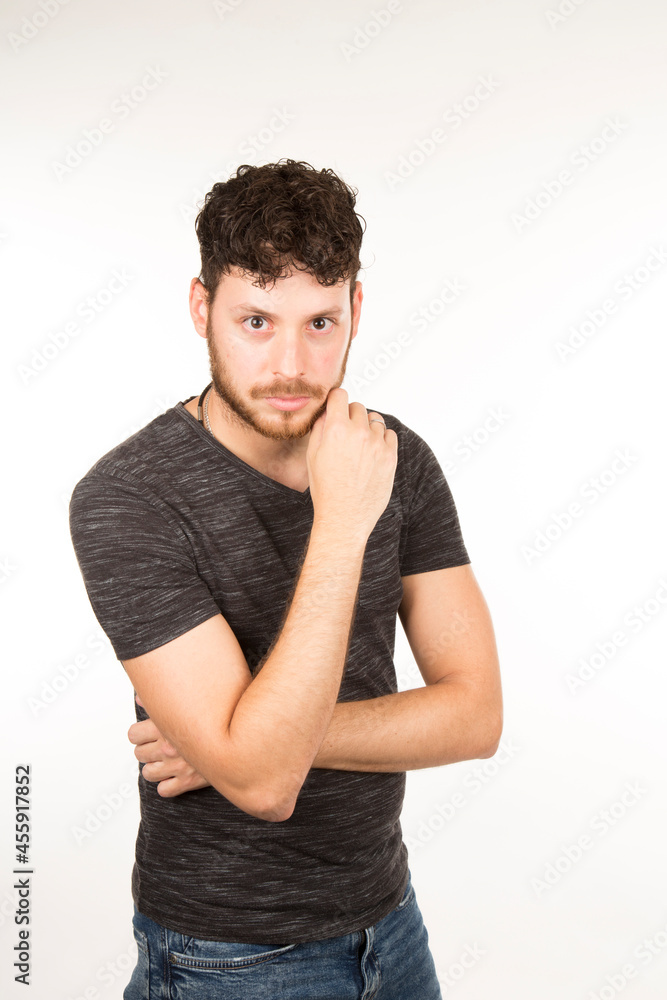 portrait young caucasian man isolated with serious expression and hand on chin portrait young caucasian man isolated with serious expression and hand on chin