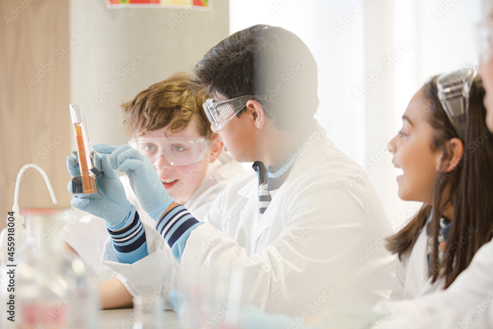 Students conducting scientific experiment in laboratory classroom Students conducting scientific experiment in laboratory classroom