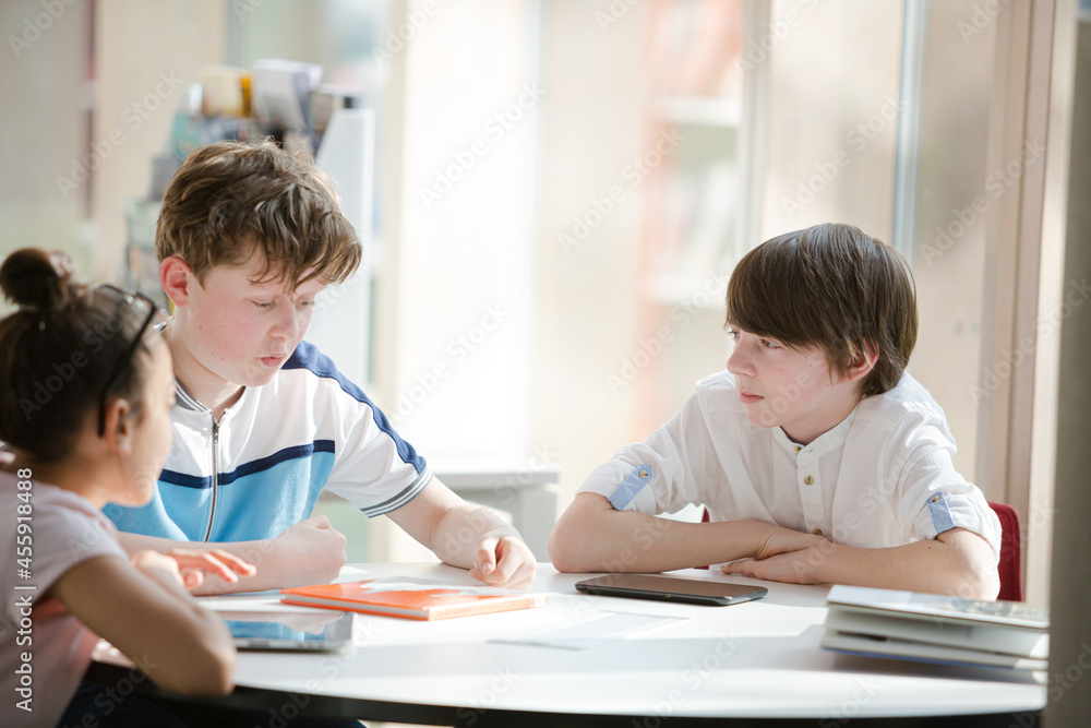 Students sitting together at table Students sitting together at table