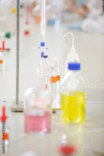Liquid in bottles, test tubes and beakers in science laboratory classroom