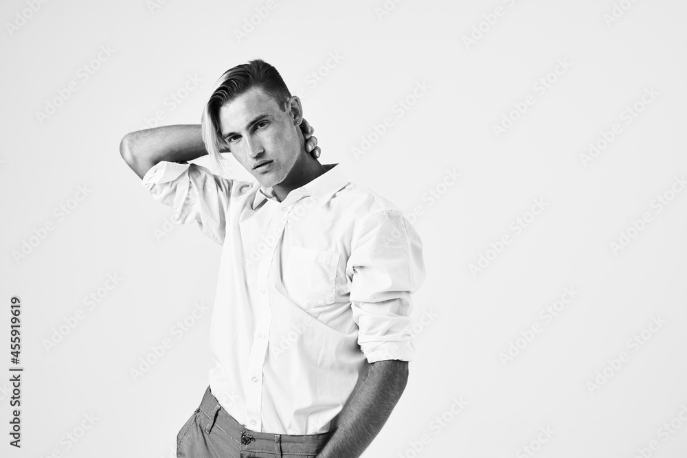 handsome man in white shirt holds his hand behind his head elegant lifestyle