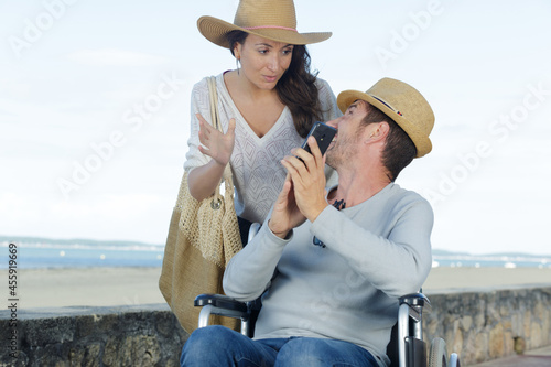 a couple in wheelchair outdors © auremar