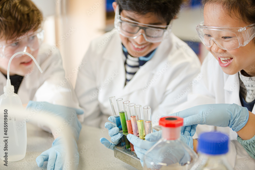 Students conducting scientific experiment in laboratory classroom Students conducting scientific experiment in laboratory classroom