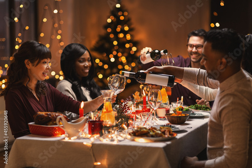 Photography holidays, party and celebration concept - multiethnic group of happy friends hav