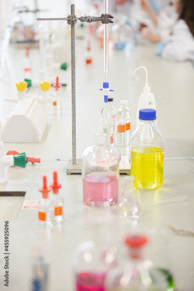 Liquid in bottles, test tubes and beakers in science laboratory classroom Liquid in bottles, test tubes and beakers in science laboratory classroom