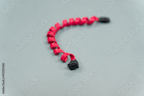 red sata (Serial Advanced Technology Attachment) wire for hard drives and ssd on gray background photo