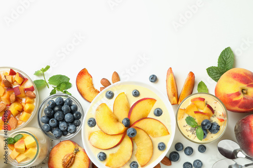 Concept of healthy food with peach yogurt and ingredients on white background