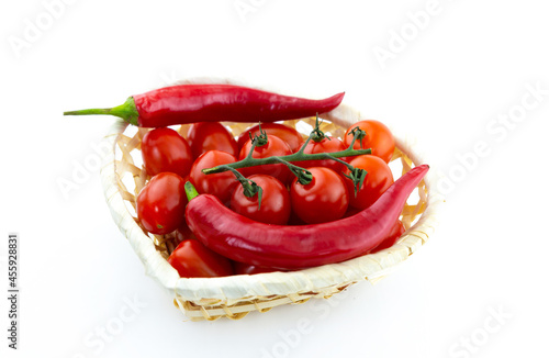 red hot peppers and cherry tomatoes base sauce on white isolated background