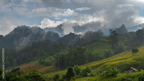 Scenic morning rural landscape panorama during monsoon season in mountain valley near Chiang Dao, Chiang Mai, Thailand 