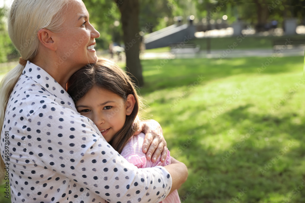 Fototapeta premium Mature woman with her little granddaughter in park