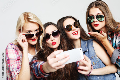 happy teenage girls with smartphone taking selfie © Raisa Kanareva