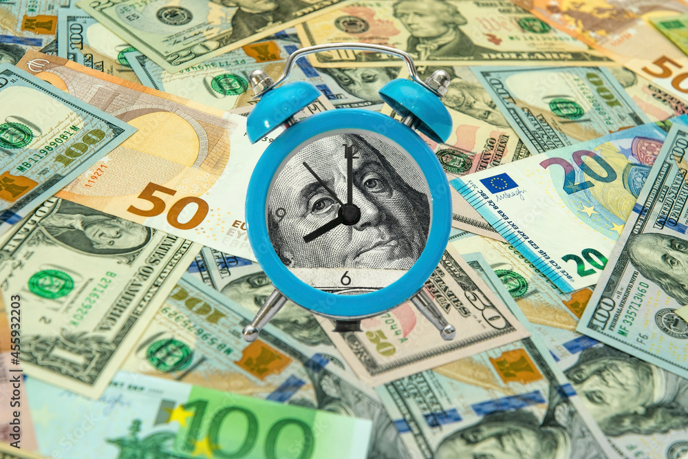 Time is money. Blue alarm clock and dollar bill Time is money. Blue alarm clock and dollar bill