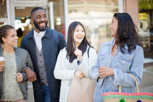 Smiling friends with coffee and shopping bags © KOTO