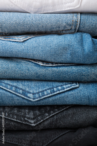 A stack of different types of jeans. Jeans of different colors. Jeans texture.