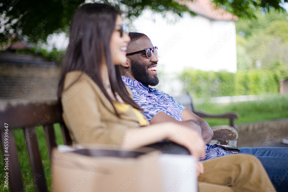 Friends sitting on park bench Friends sitting on park bench